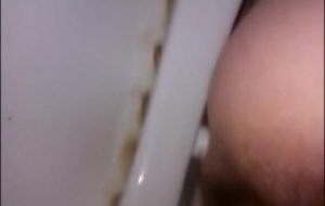 Hairy woman shitting in a dirty toilet closeup